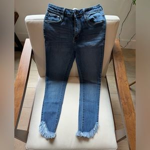 Just black denim, size 26 skinny jeans. Cute flared raw hem.